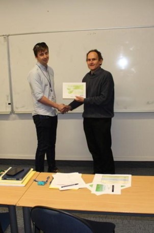 Matthew Lofroth accepts the runner up award for his micro-gripper development work