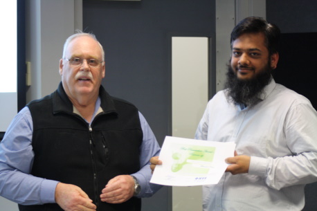 Muhammad Rehan accepts the runner-up award for his micro-gut capsule development work.